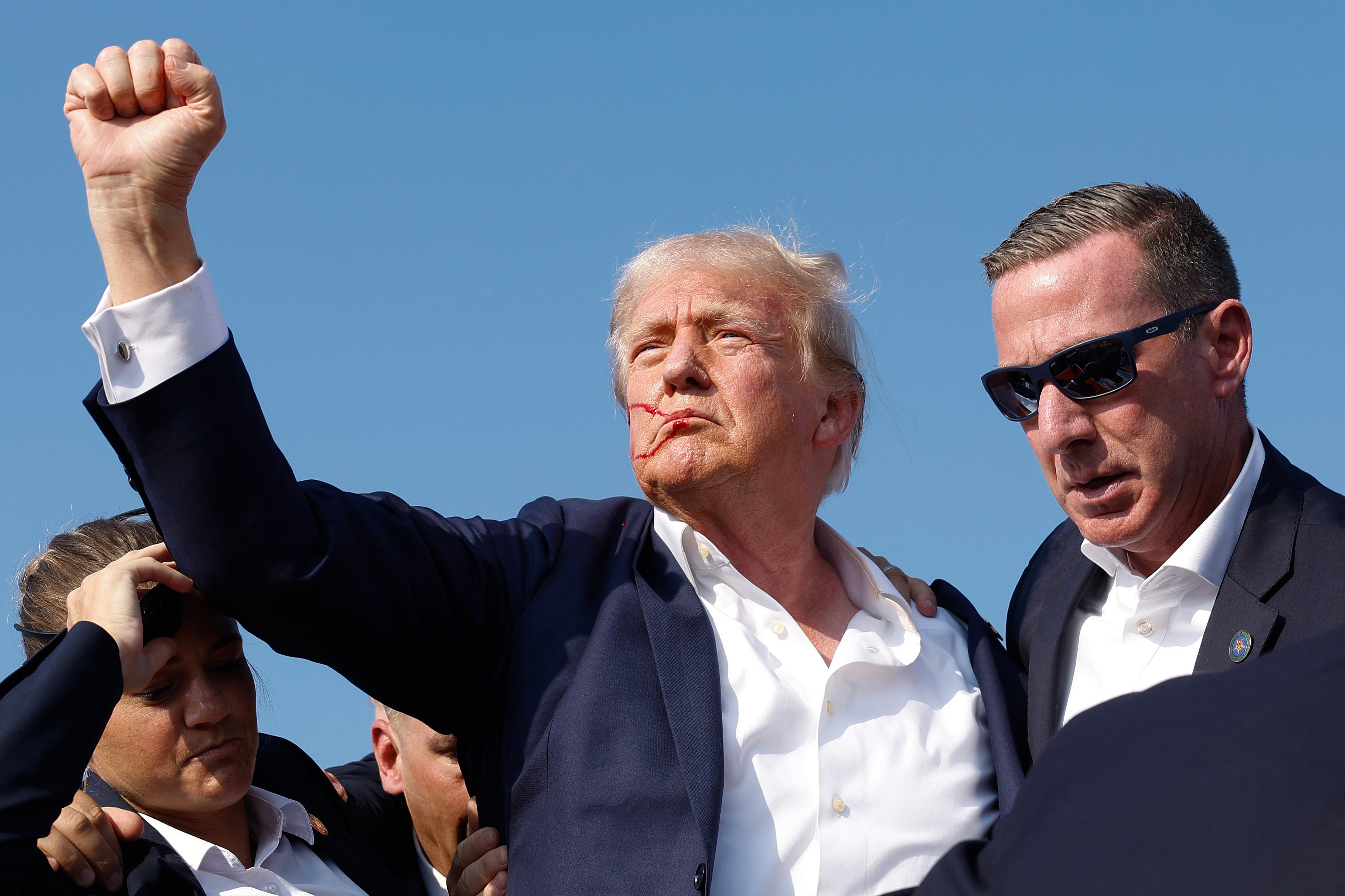Donald Trump raises his fist after being shot at the campaign rally in Butler, Pennsylvania on July 13 last year. Aides thought the then-presumptive Republican presidential nominee had been shot ‘four or five times’ because there was so much blood, according to a new book