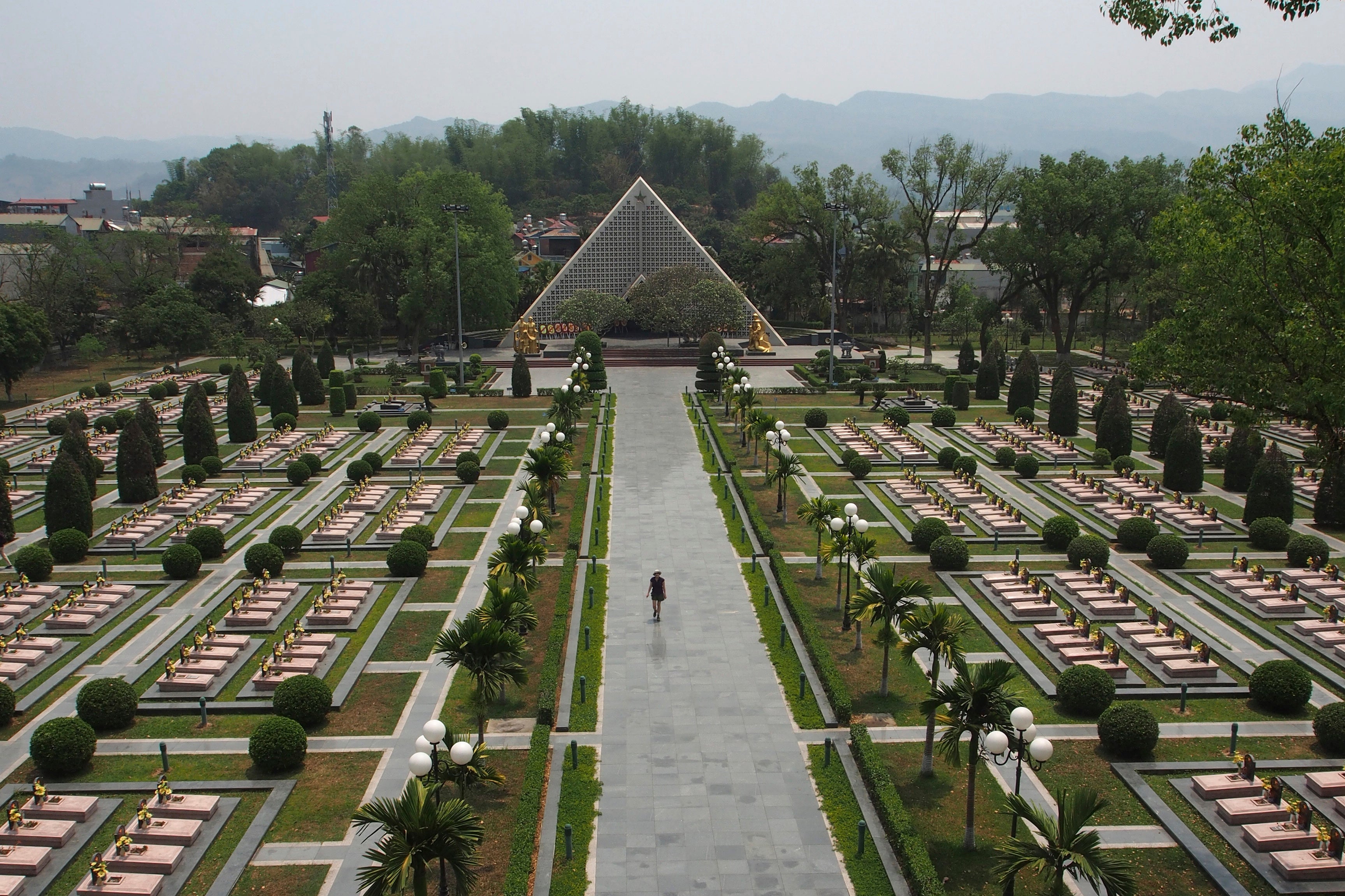 A tourist walks through the Dien Bien Phu Military Cemetery